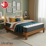 UltraFlex Hercules mattress on a wooden bed with teal bedding against a green wall.
