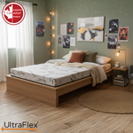UltraFlex Atlas mattress on a wooden bed with a patterned cover and neutral bedding.