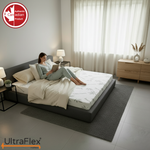 Person reading on an UltraFlex Supreme mattress in a bright bedroom.