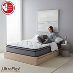 Person reading while seated on an UltraFlex Titan Firm mattress.