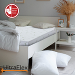 UltraFlex SleepTight mattress on a white bed frame beside a small bedside table.