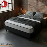 Angled bedroom view of the UltraFlex DreamWeaver mattress and black base.