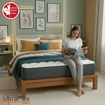 Person reading while seated on the edge of an UltraFlex Hercules mattress.