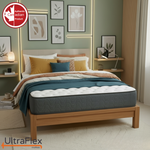 UltraFlex Hercules mattress with teal bedding on a wooden bed in a green bedroom.