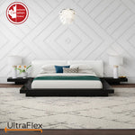 Bedroom with a low platform bed and geometric white wall panelling.