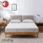 Front view of the UltraFlex SolidSleep mattress with two pillows on a wooden bed.