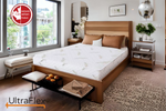 Sunlit bedroom with an UltraFlex EcoZen mattress on a wooden platform bed.