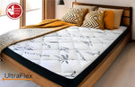 Angled close-up of the UltraFlex DreamEasy mattress on a wooden bed, showing its bamboo-patterned cover.