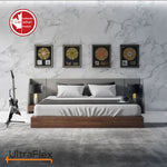 Bedroom with white bedding, dark pillows and framed records on a marble-patterned wall.