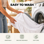 Comfort Living mattress protector being removed for machine washing beside a washing machine.