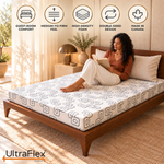 Woman reading on an UltraFlex Divine high-density foam mattress in a guest bedroom.