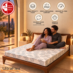 Couple relaxing on an UltraFlex Divine double-sided foam mattress in a bedroom at sunset.