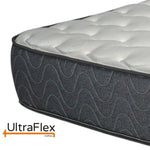 Close-up of the UltraFlex Classic mattress corner and wave-patterned grey fabric.